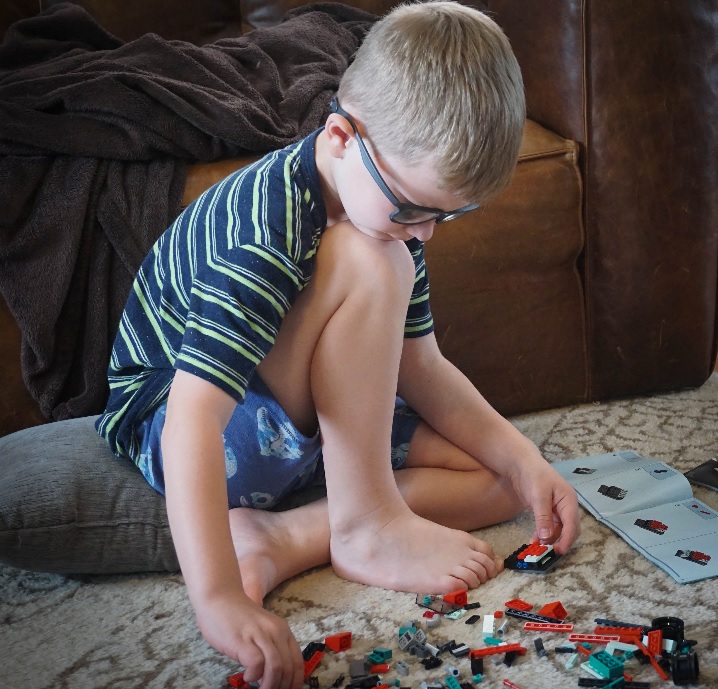 7-yr-old Lego master boy building with Legos